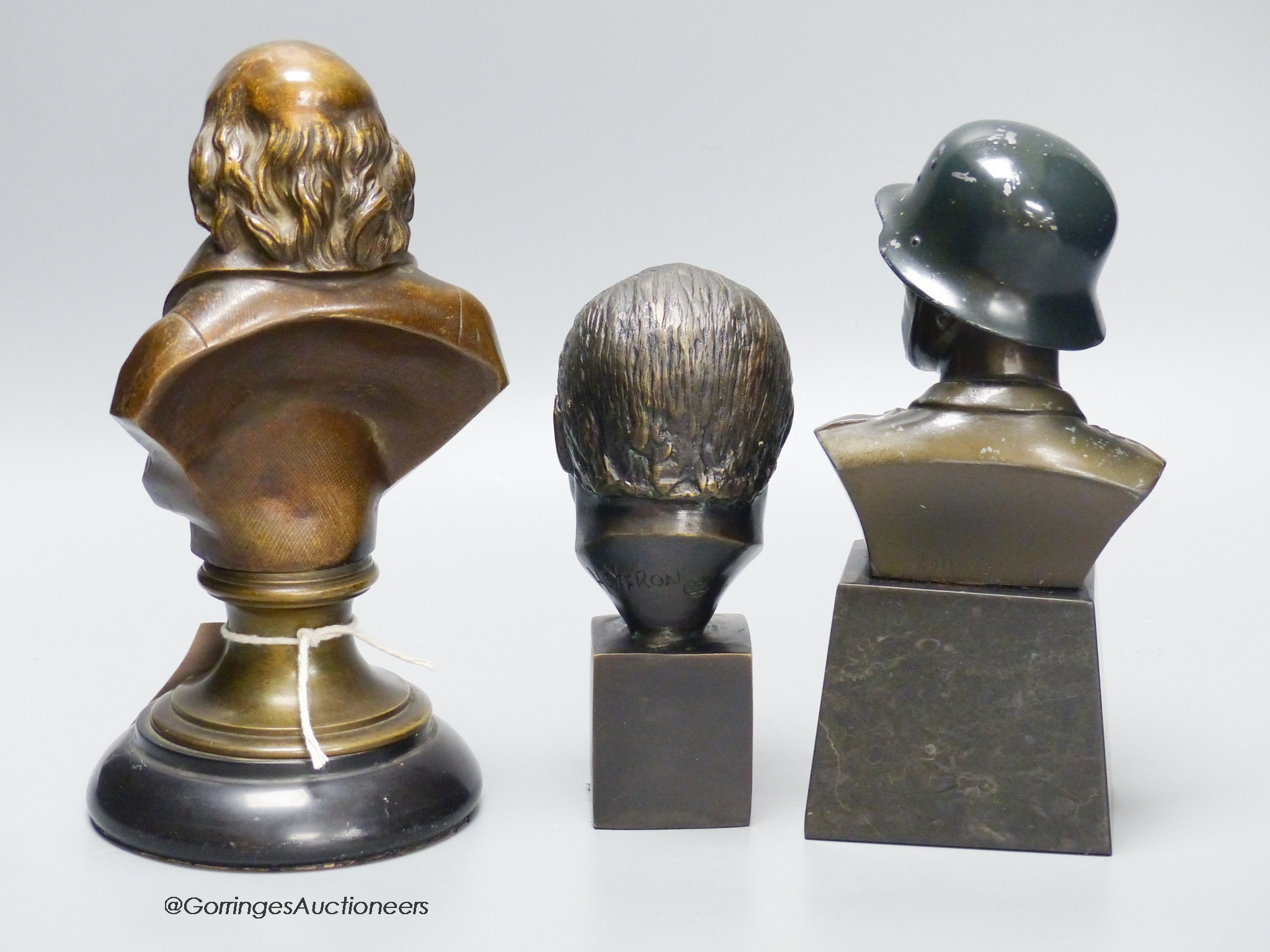 Three cast metal portrait busts, tallest 22cm